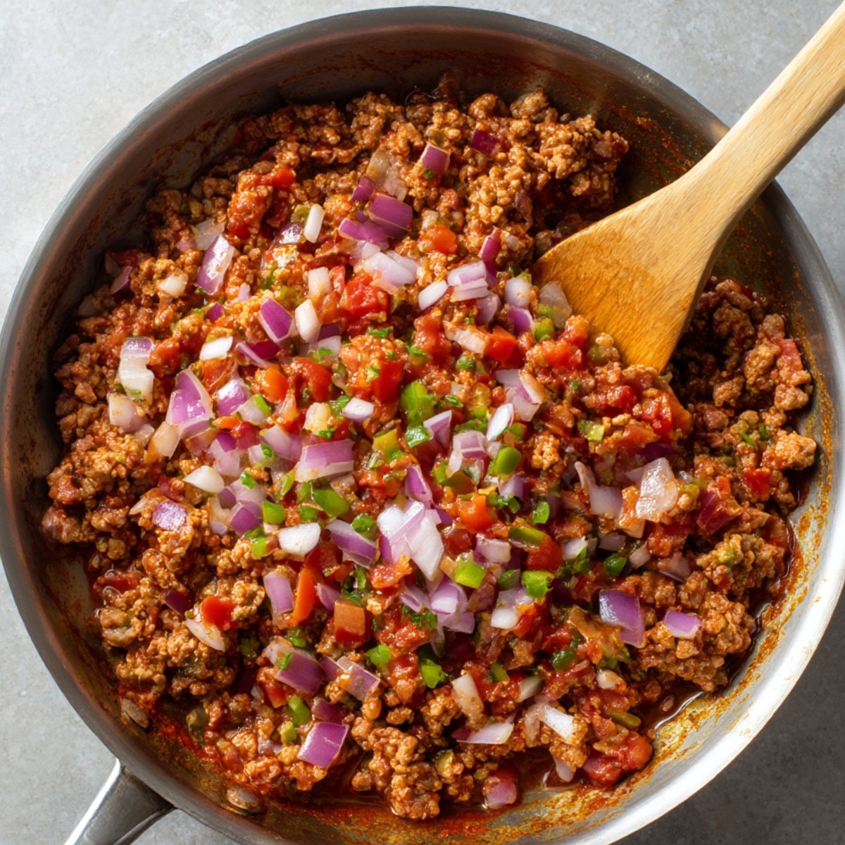 Assorted taco ingredients displayed in small glass bowls—black beans, diced tomatoes, corn kernels, sliced jalapeños, cilantro, and chopped onions.